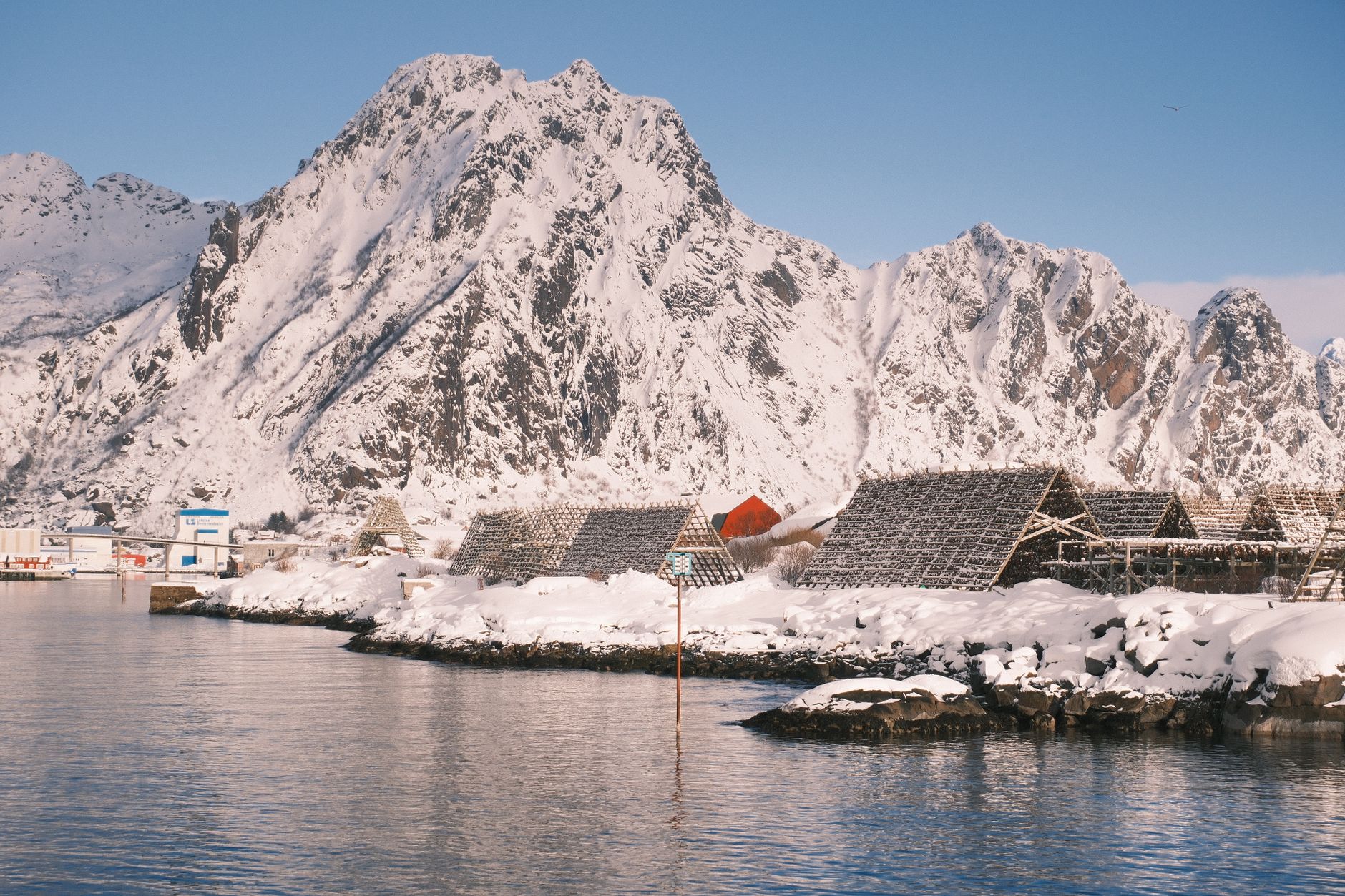 Snow covered peaks and fjord cabin in Norway